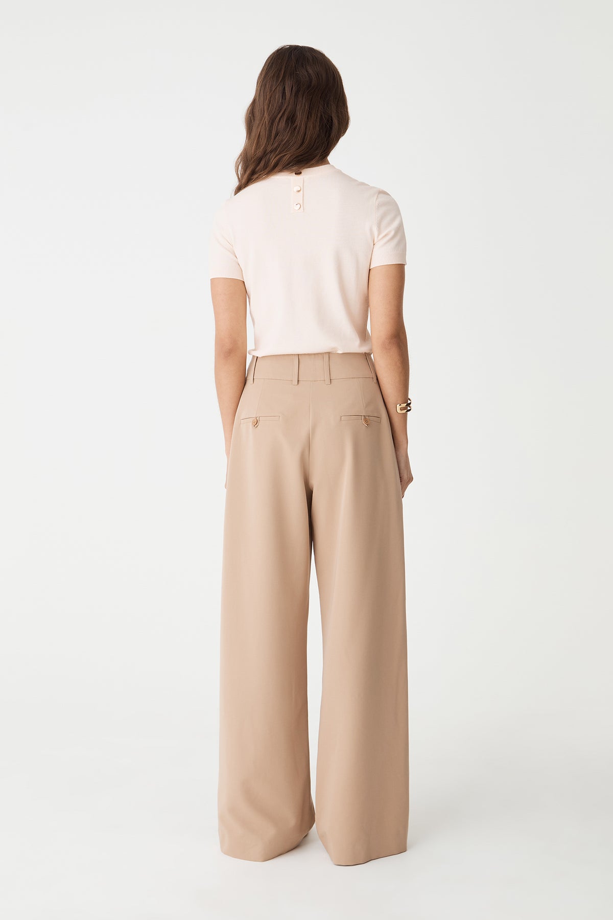 Back view of the Alabaster knit top showing back neck button detail