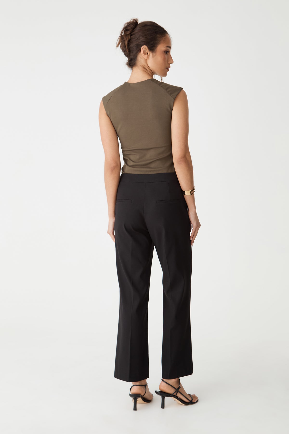 Back view of the mocha brown top with black trousers