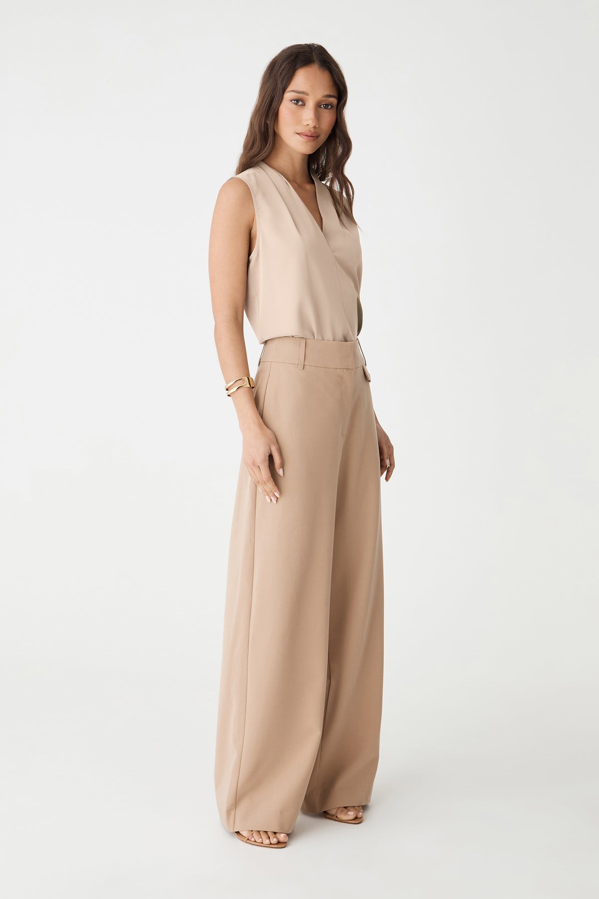Side view of the bone top with beige wide-leg trousers