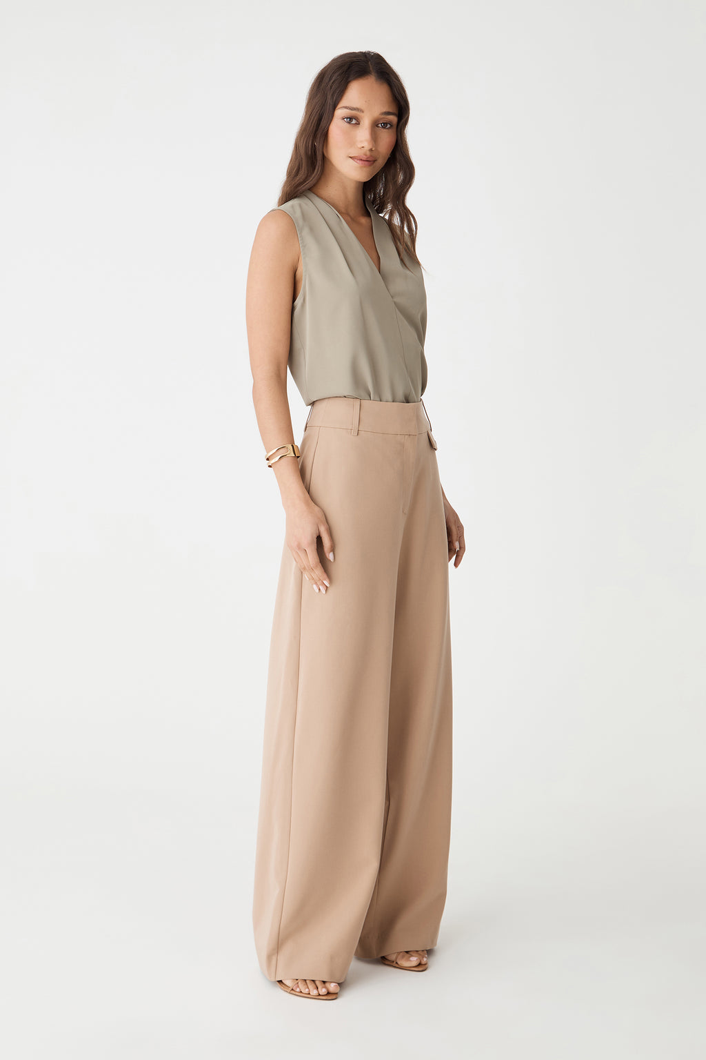 Side view of the khaki Alivia 2 V-Neck Top with beige wide-leg pants