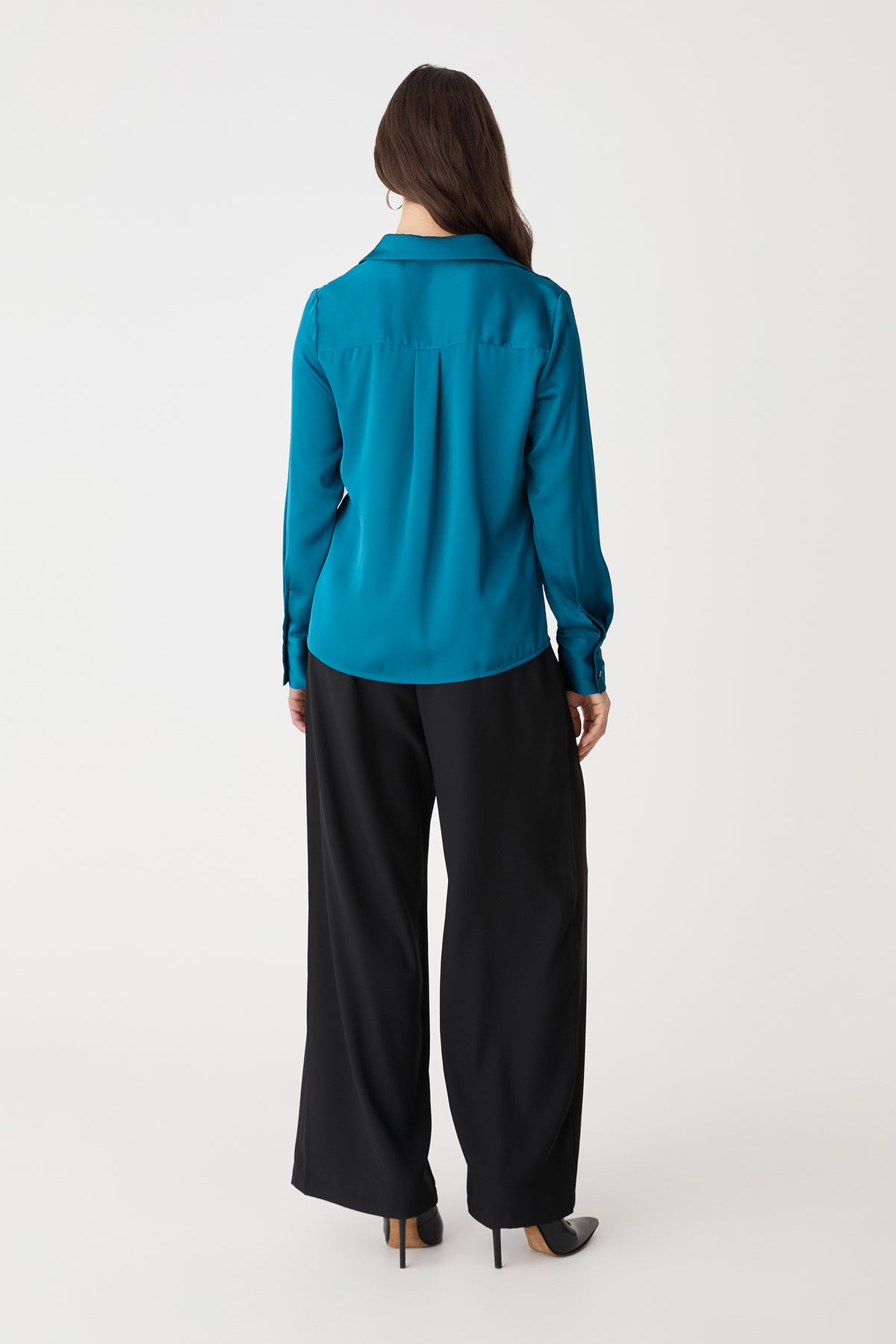 Back view of the aquamarine blouse with black wide-leg trousers