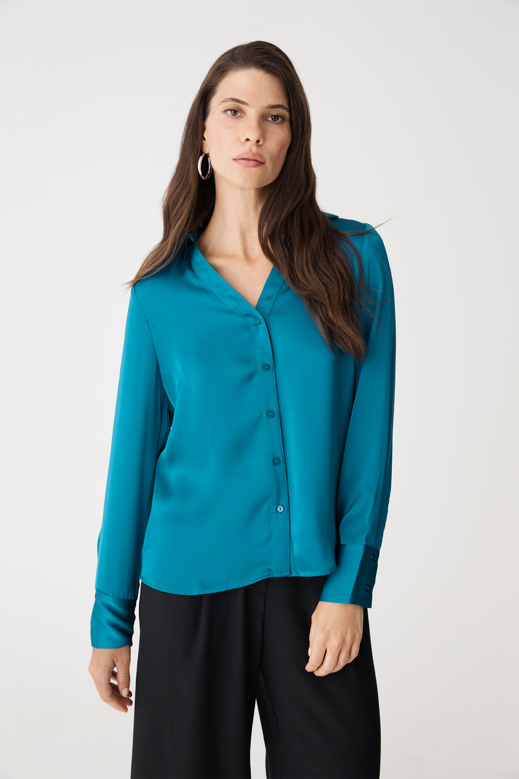 Front close view of the aquamarine blouse showing V-neckline and button front