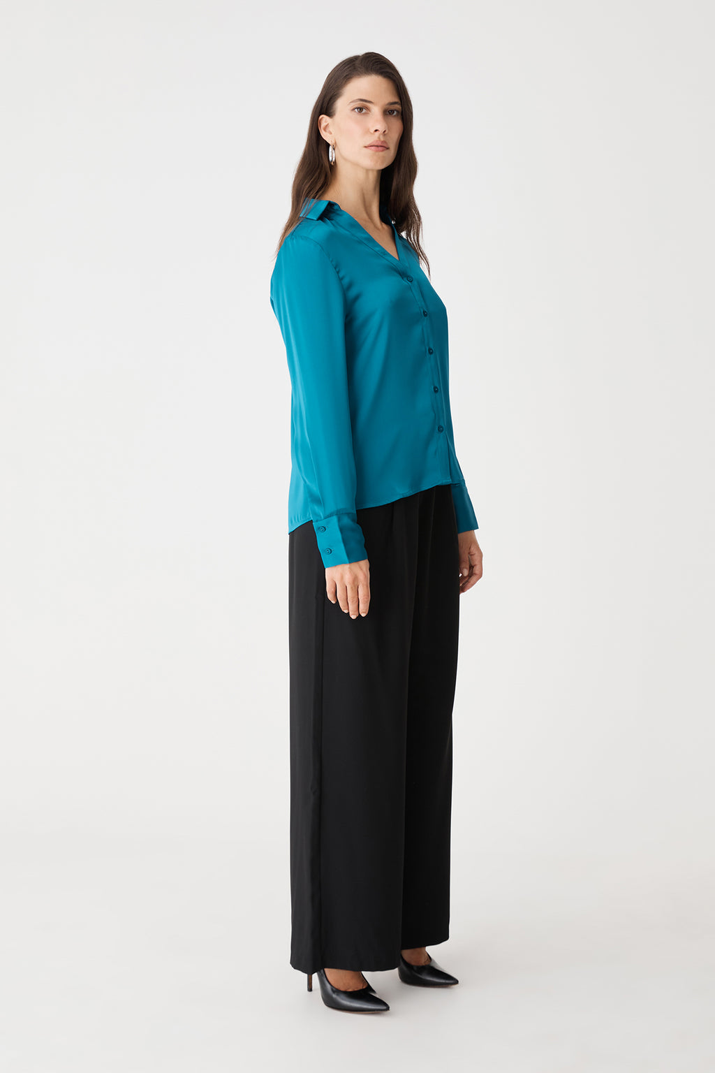 Side view of the aquamarine blouse with black trousers