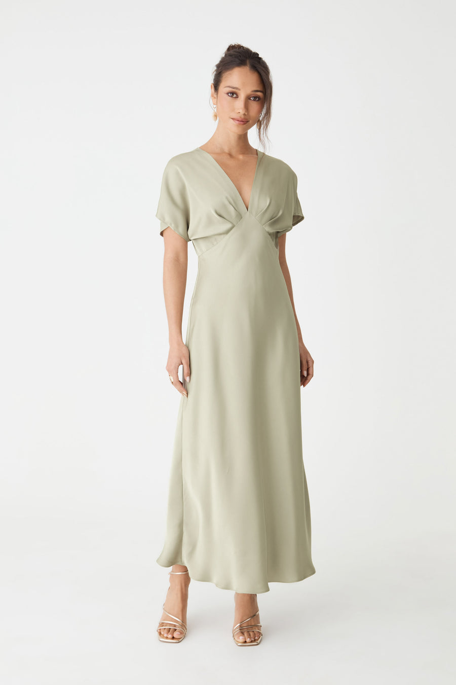Catalina V-Neck Satin Dress in sage, front view with batwing sleeves and bias-cut midi skirt, worn with heels