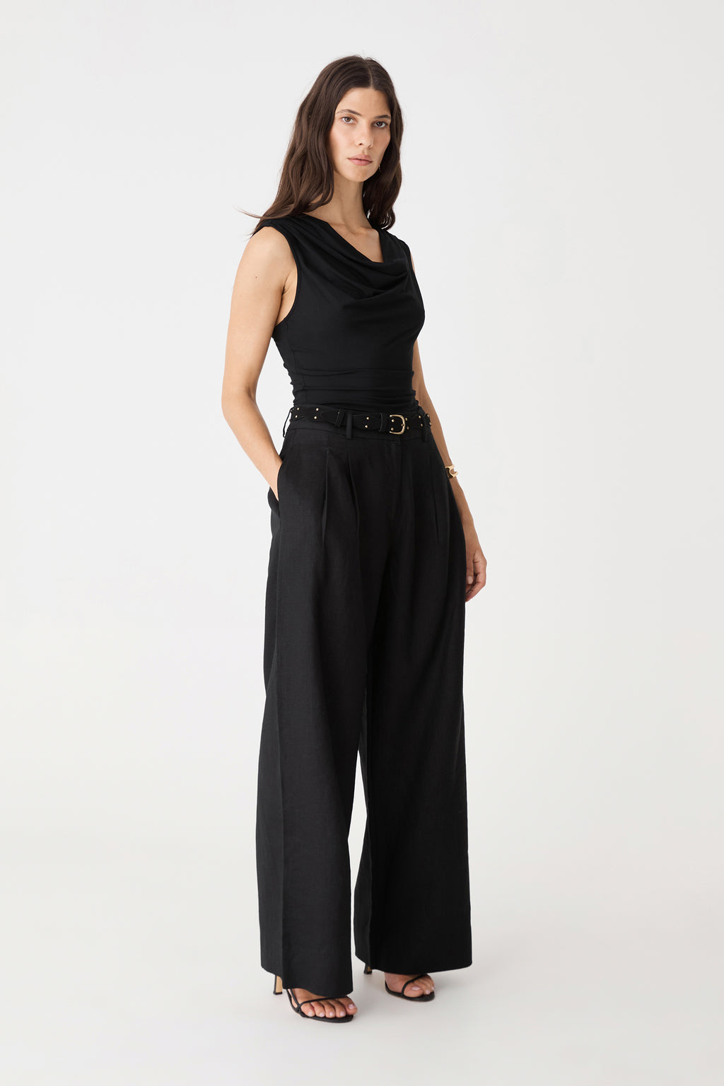 Side view of the black Ami Wide Leg Linen Pants worn with matching vest