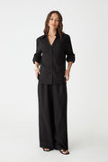 Jazie Tencel Linen Tab Shirt in black, front view worn open-neck with black wide-leg pants