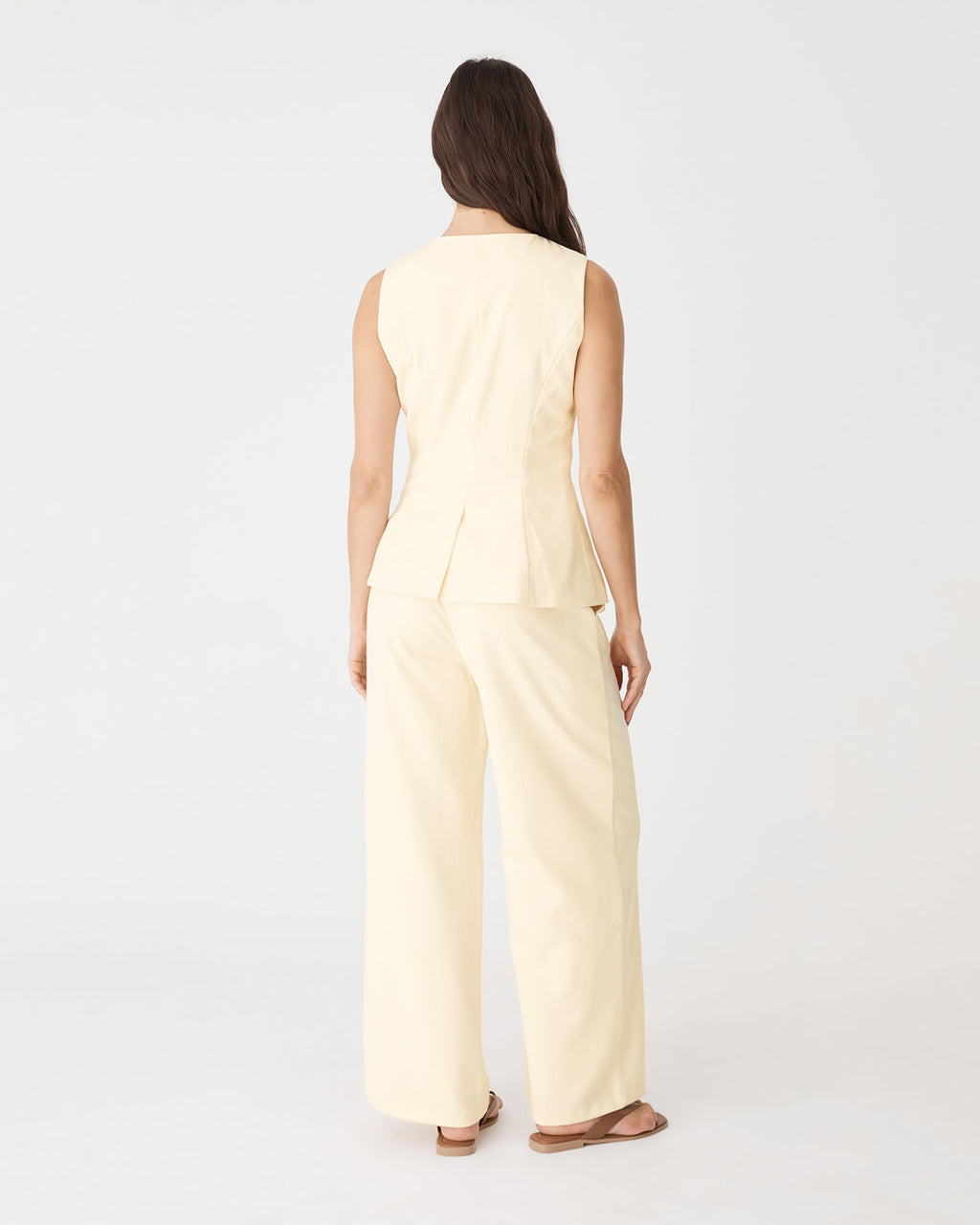 Back view showing flared hem and back vent of the butter vest