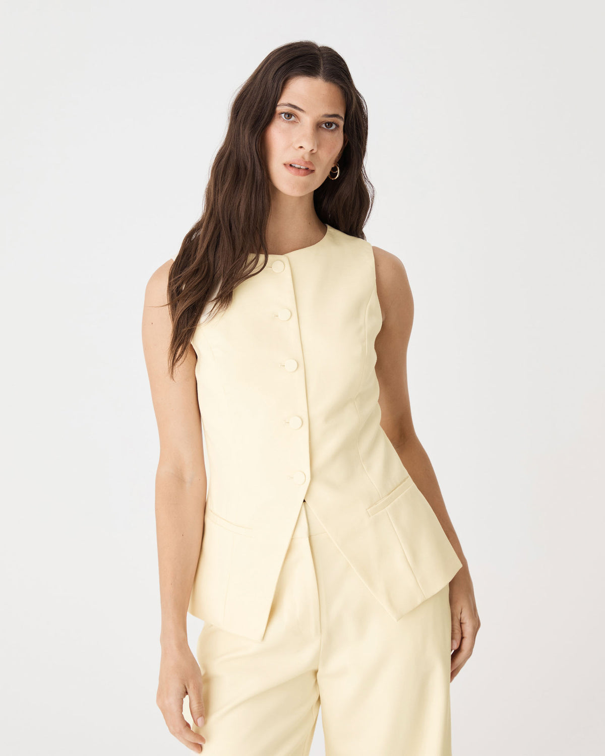 Front close-up of the butter vest showing round neckline and fabric-covered buttons