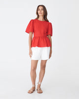 Jade Linen Peplum Top in red — full-length view