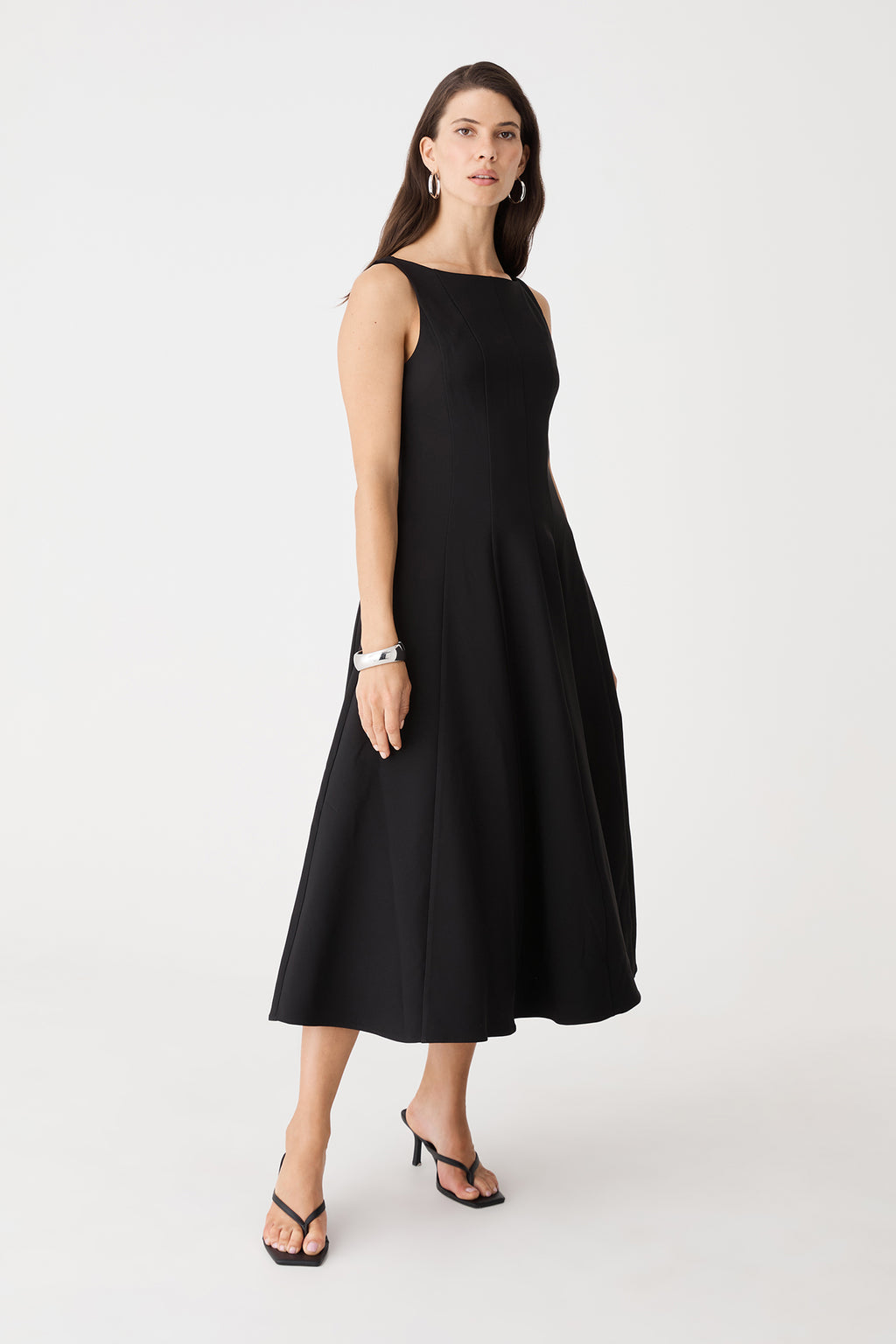 Side-angle view of the black sleeveless midi dress