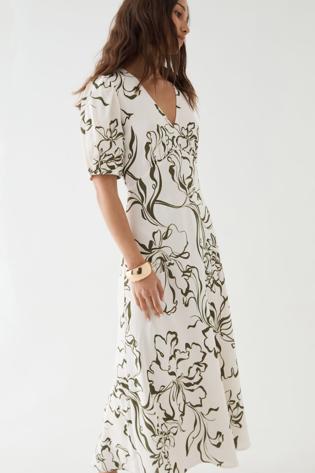 Side view showing puff sleeve, gathered empire waist and midi skirt