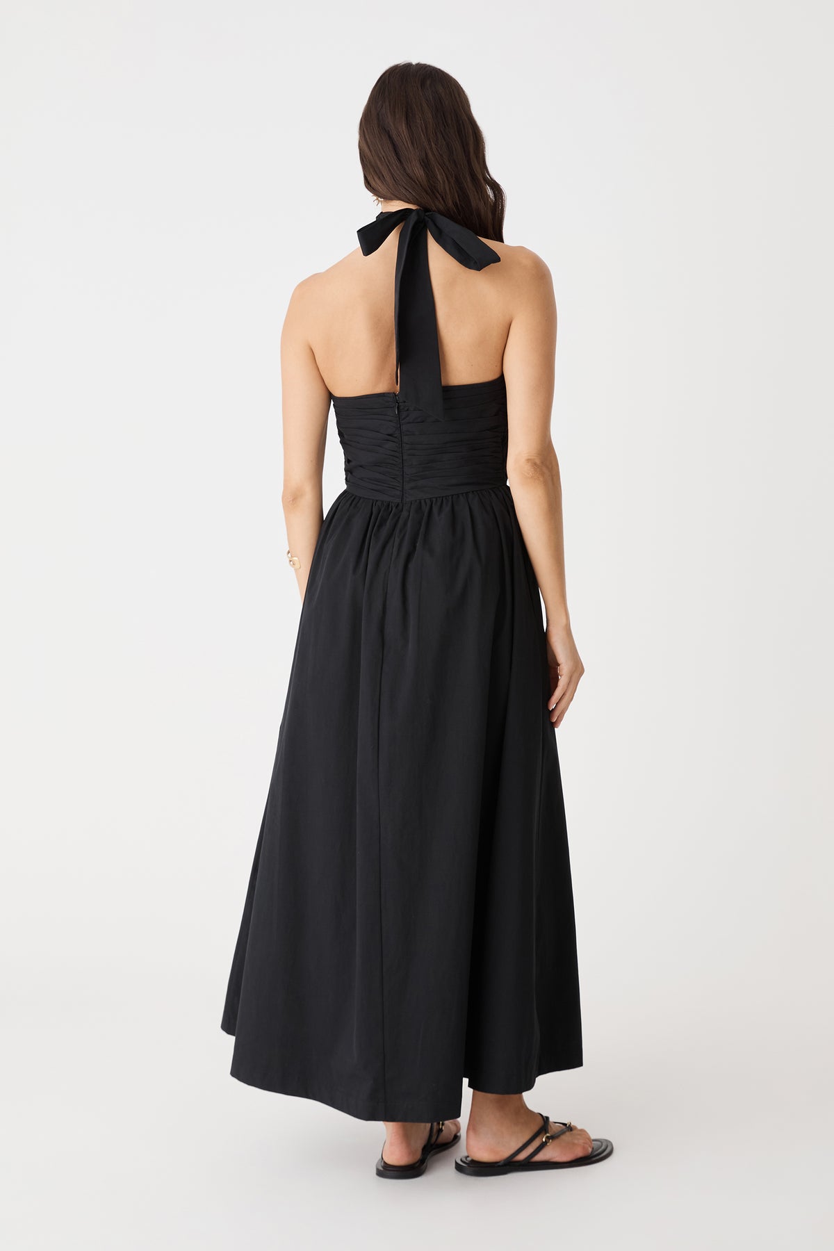 Back view showing the open back and neck tie of the black Kayleigh Cotton Halter Dress