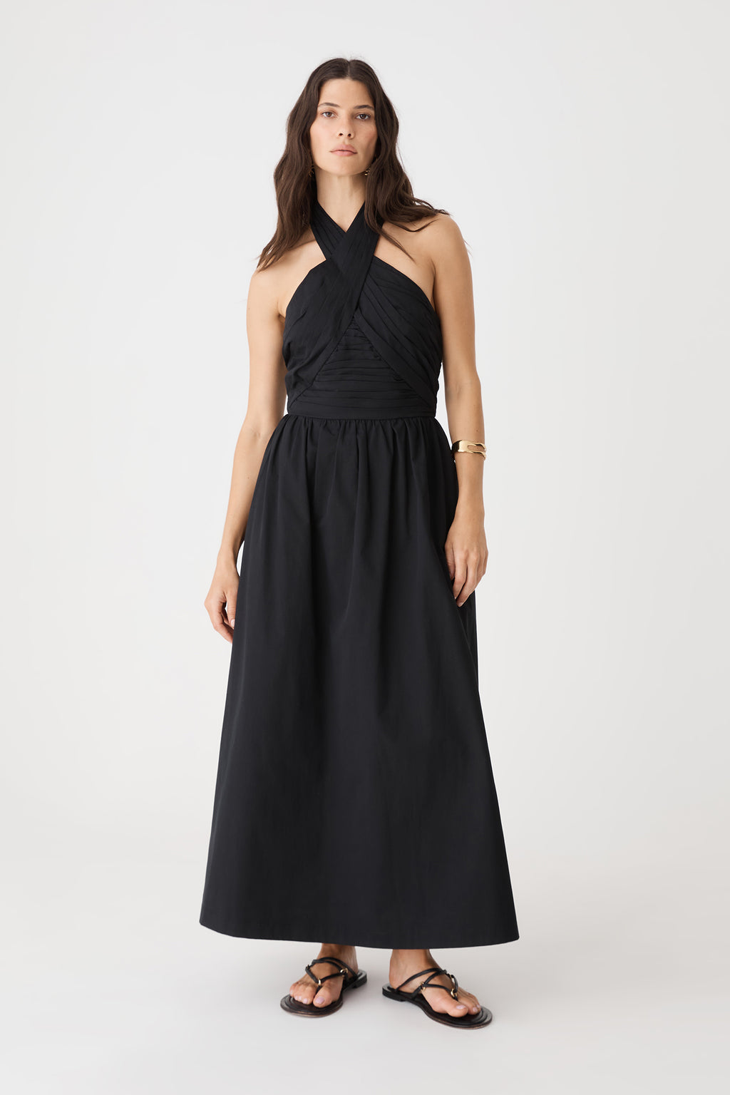 Front view of the black Kayleigh Cotton Halter Dress worn with black sandals