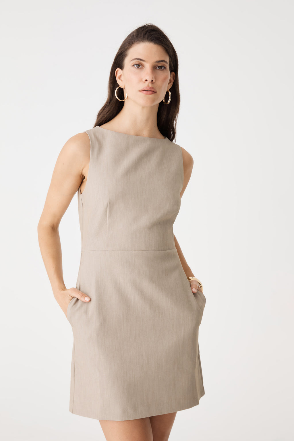 Front detail with hands in the in-seam side pockets of the Driftwood mini dress