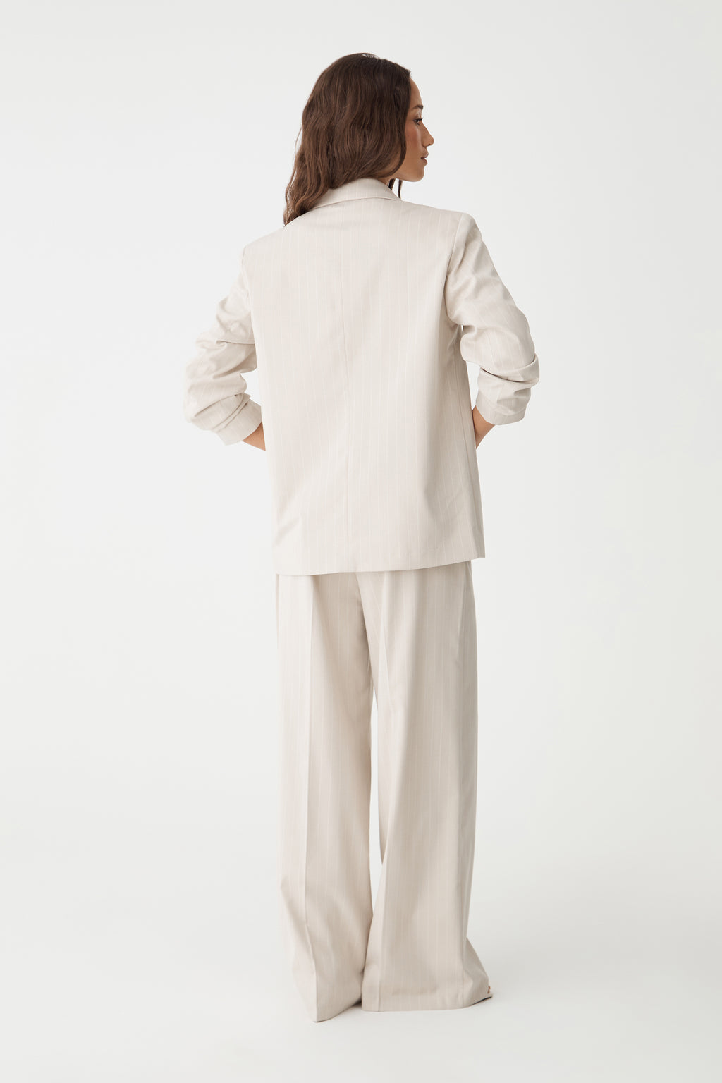 Back view of the beige pinstripe blazer and matching trousers