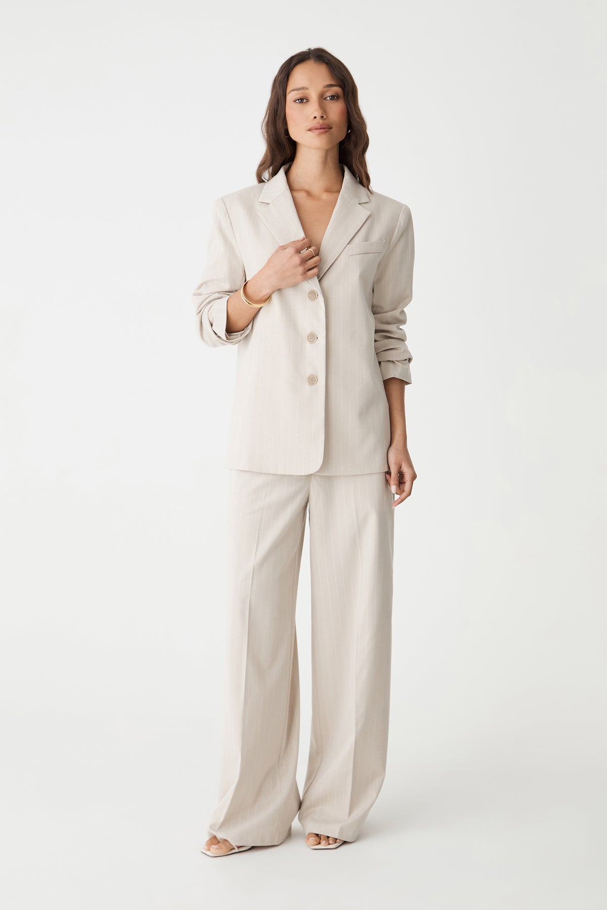 Zoe Relaxed Pinstripe Blazer in beige pinstripe, front view worn with matching wide-leg trousers