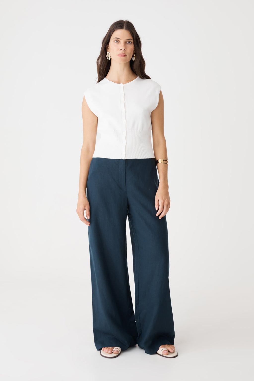 Faye Sleeveless Button Up Knit in ivory, front view worn with navy wide-leg trousers