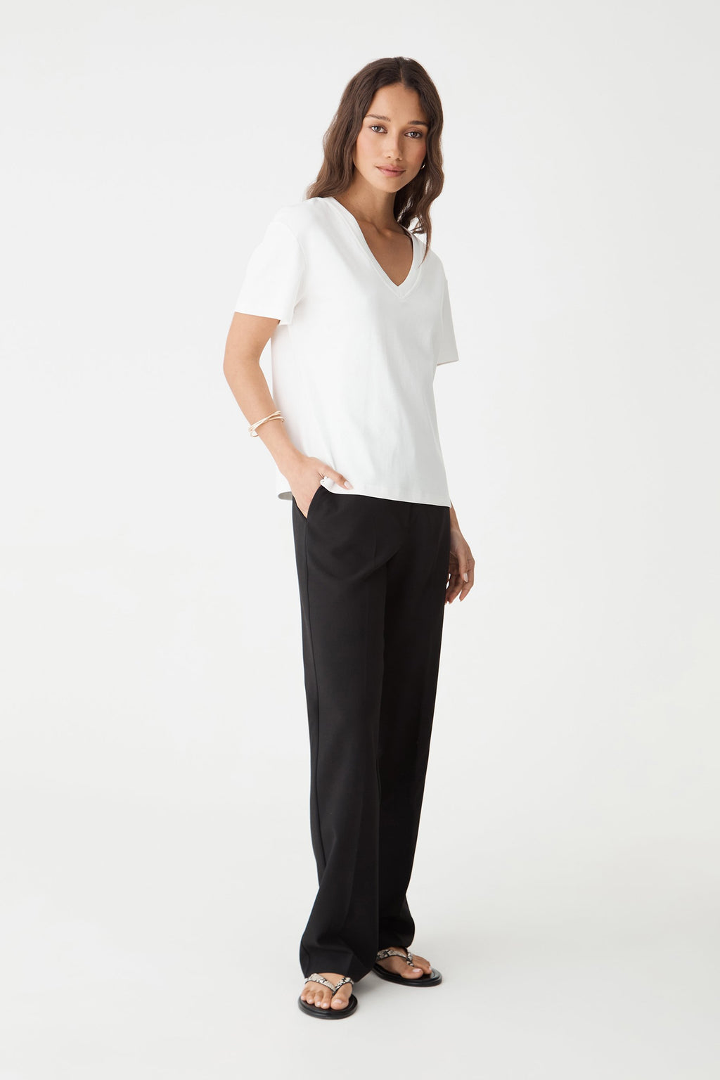 Side view of the black Nikki pants with hand in pocket