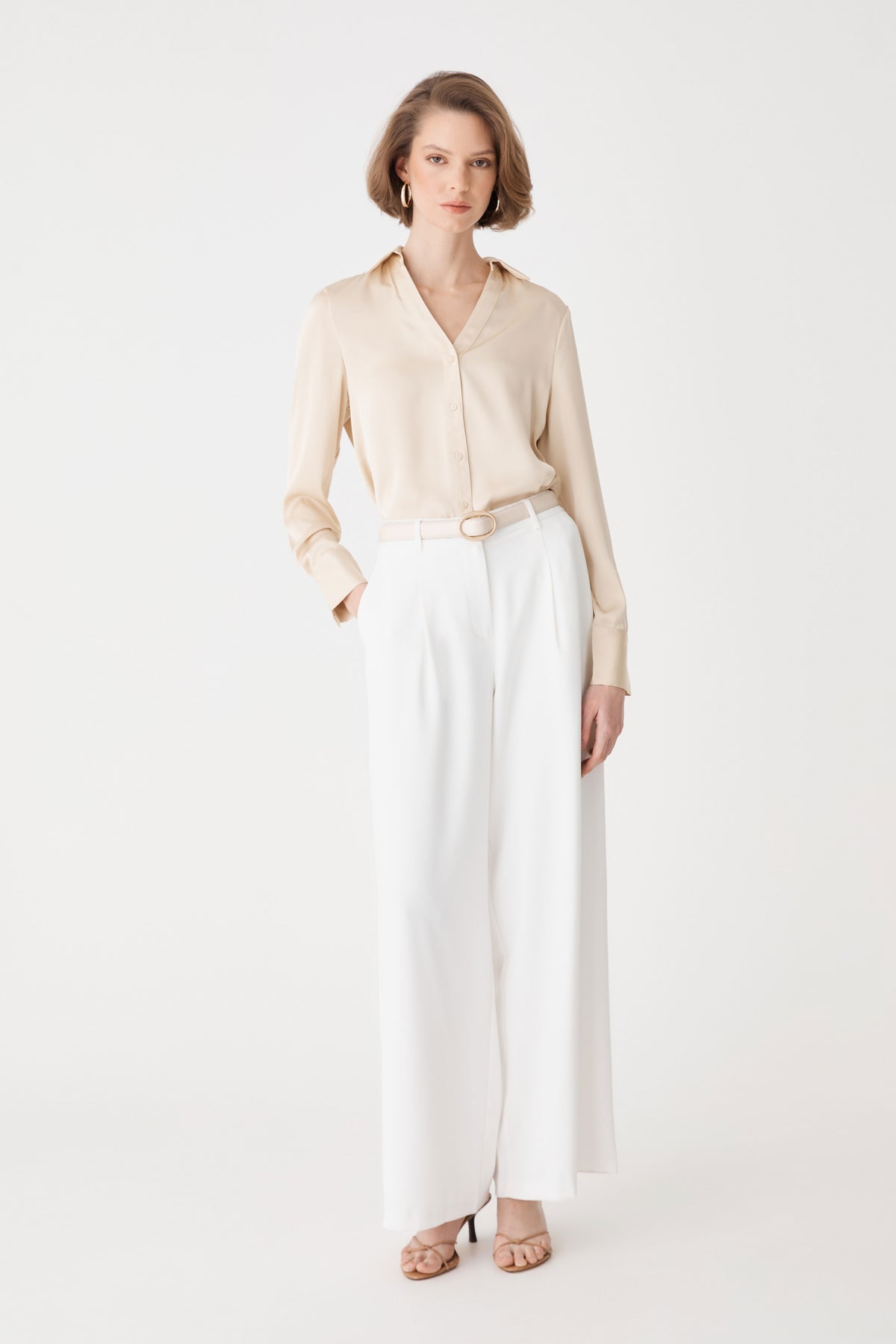 Daphne Pleated Crepe Pants in ivory, front view, worn with a beige shirt tucked in