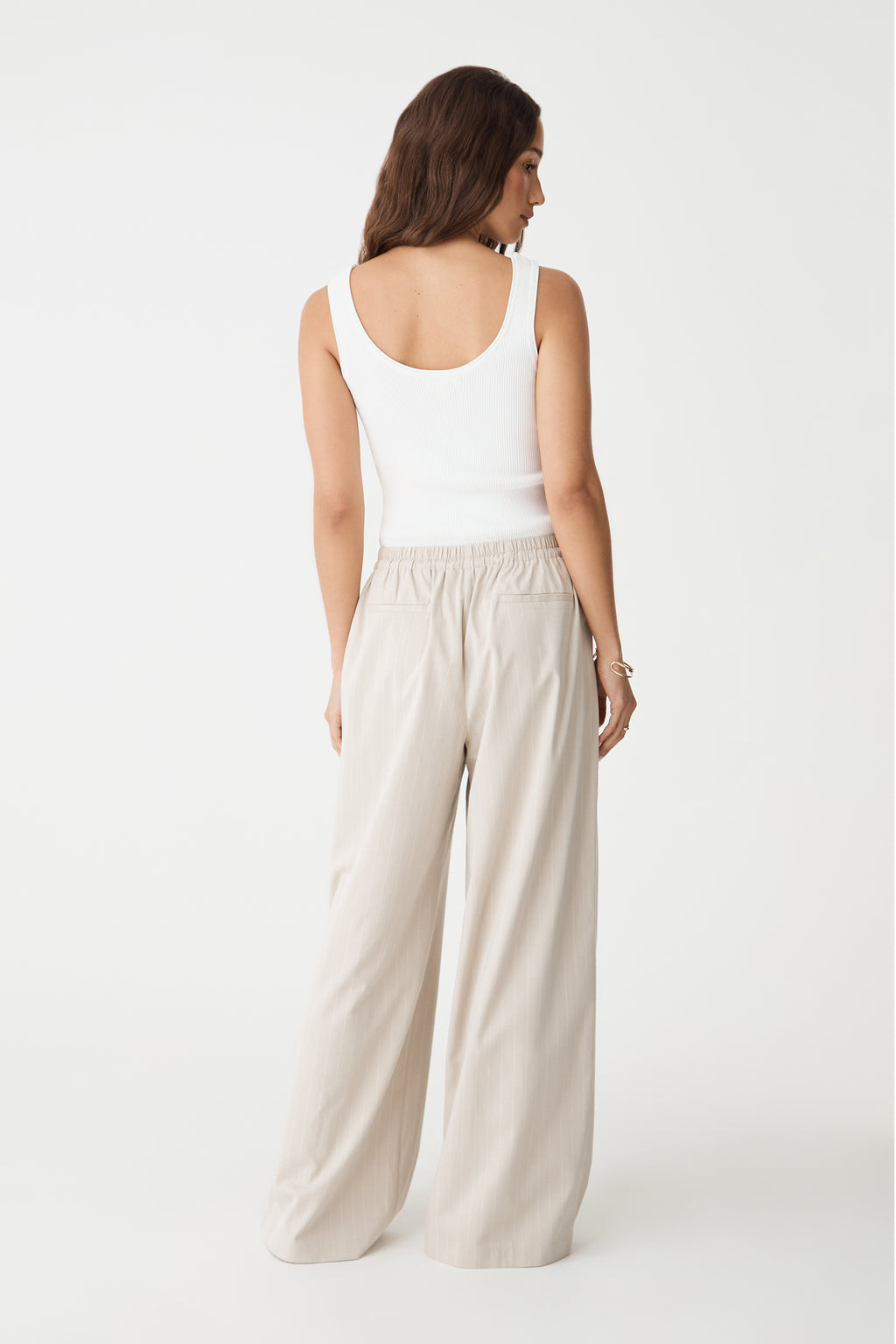 Back view showing welt pockets and wide-leg shape