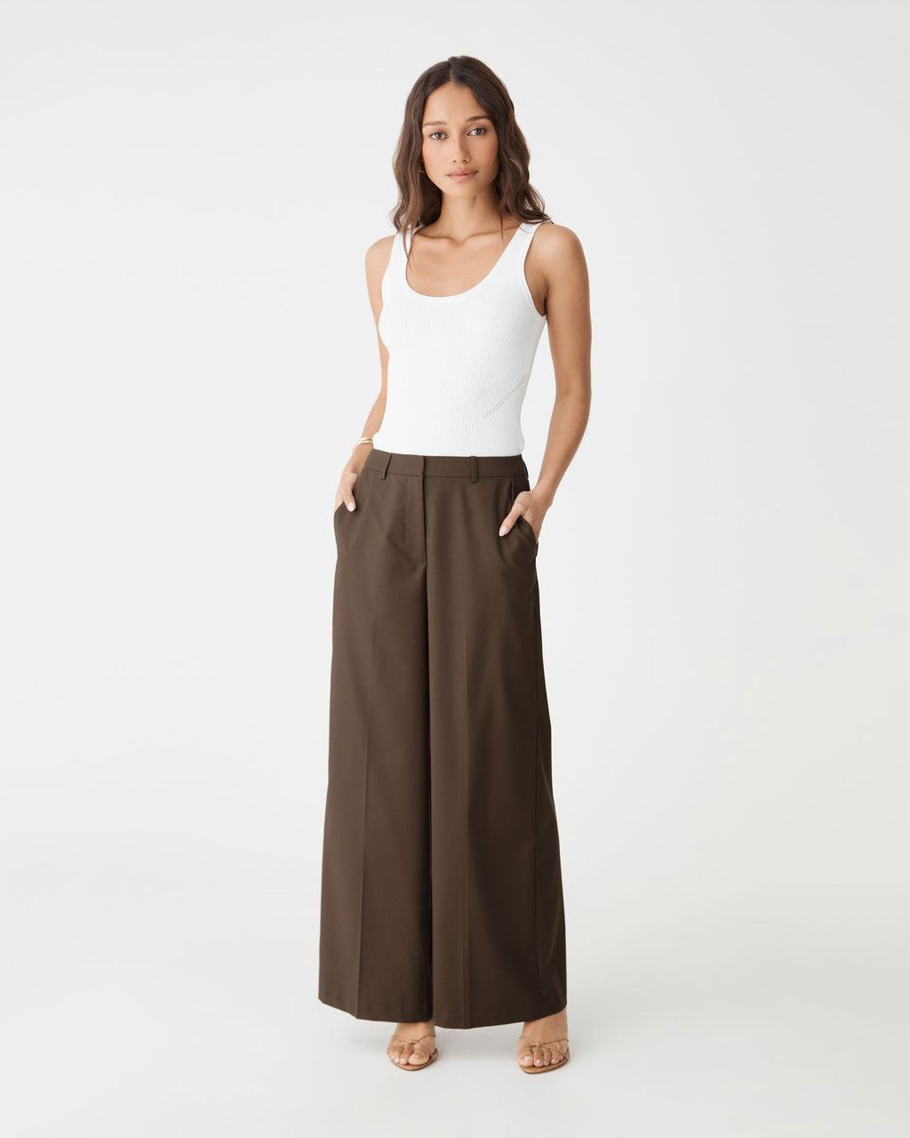Front view with hands in the side pockets of the cocoa brown wide leg pants