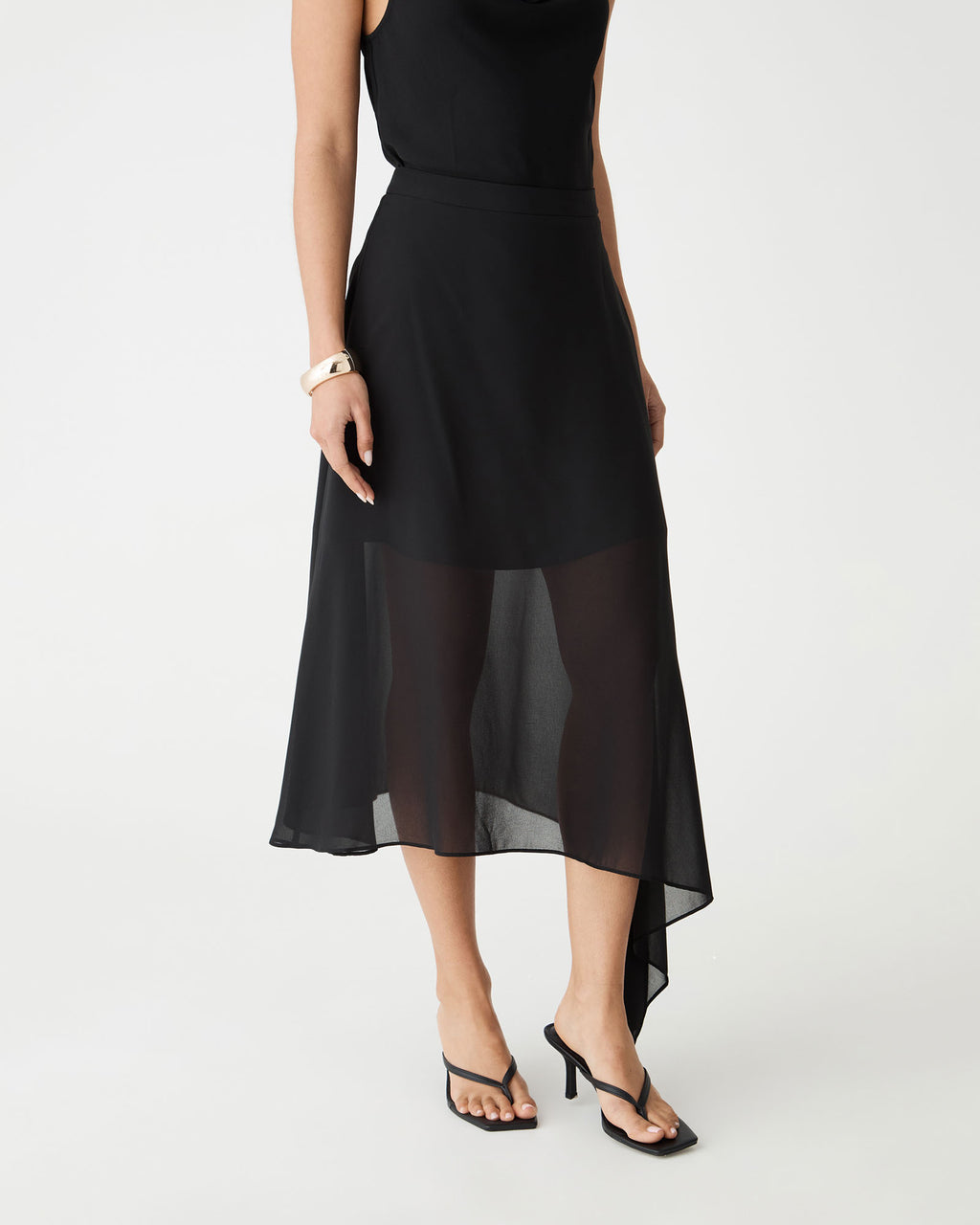 Close-up front view of the sheer chiffon asymmetric hem and fitted waistband