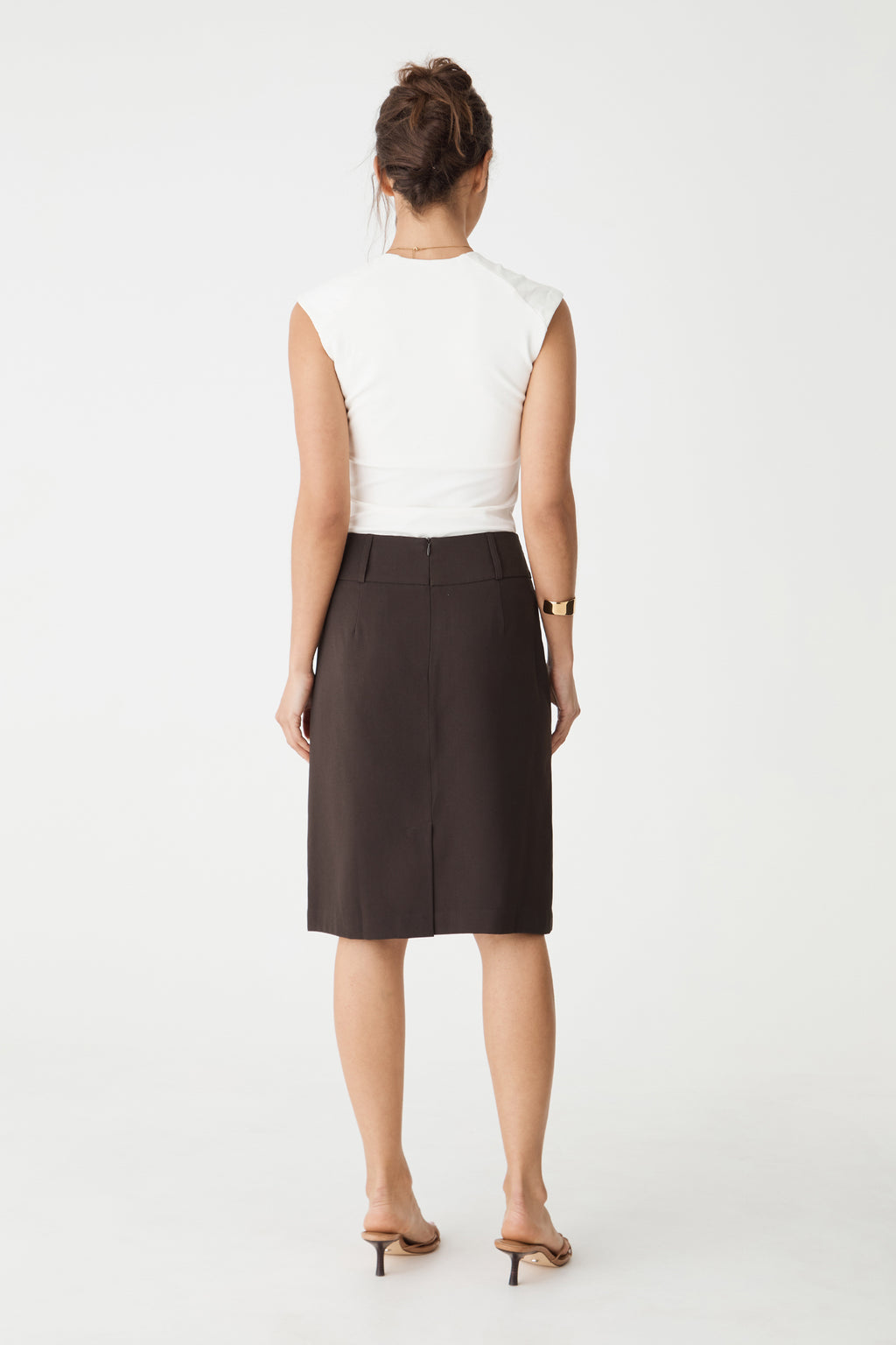 Back view showing centre-back seam and vent of the chocolate skirt