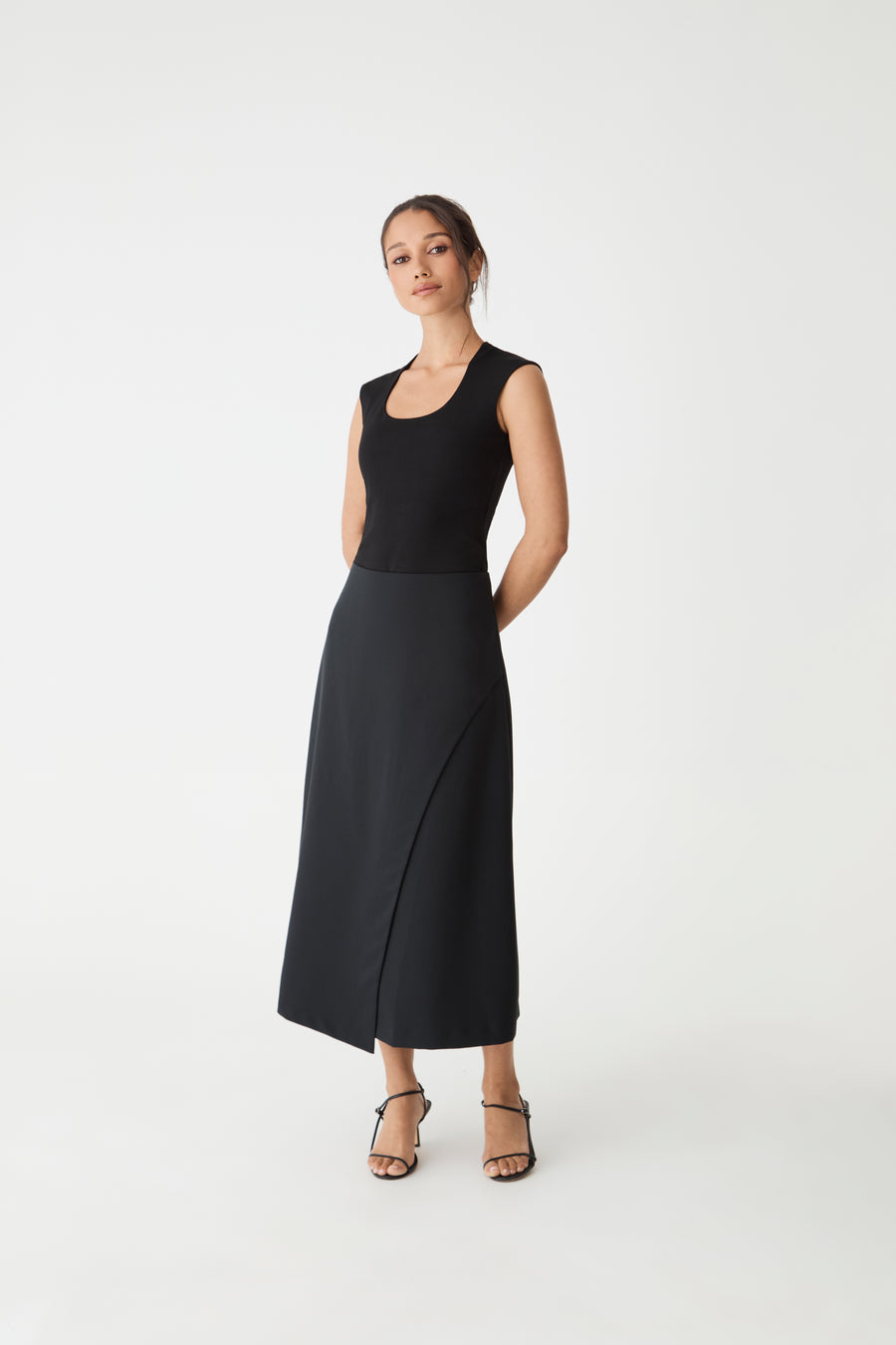 Jennifer ALine Faux Wrap Skirt in black, front view worn with a black sleeveless top