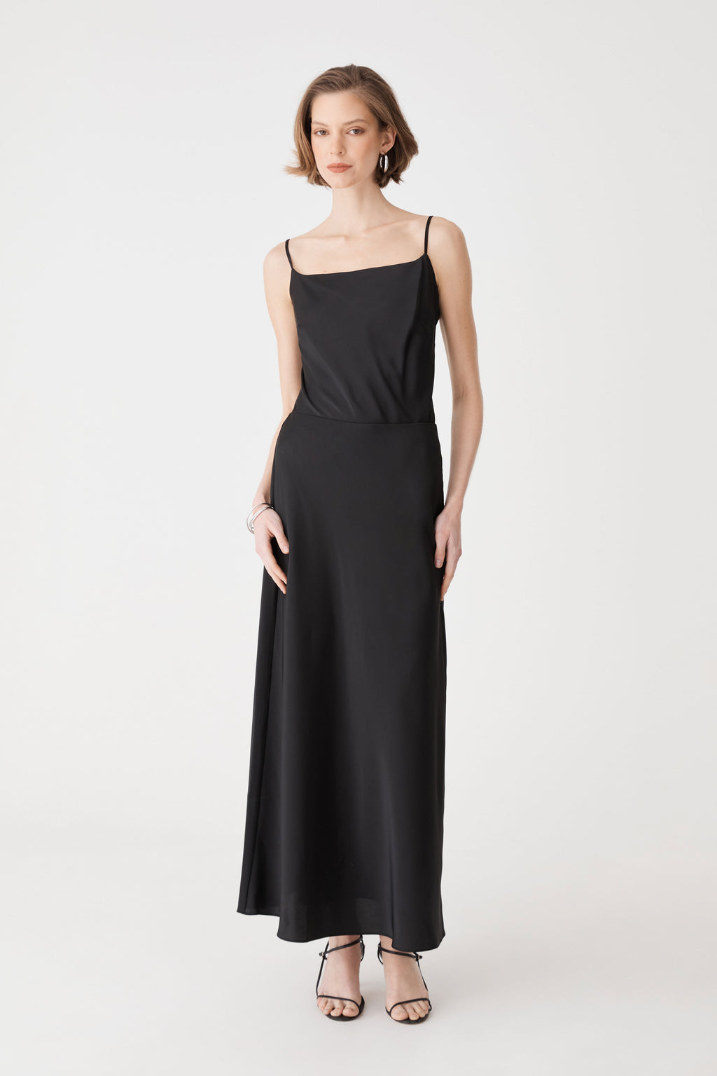 Louise Bias Satin Skirt in black, front view, maxi length worn with a black camisole top