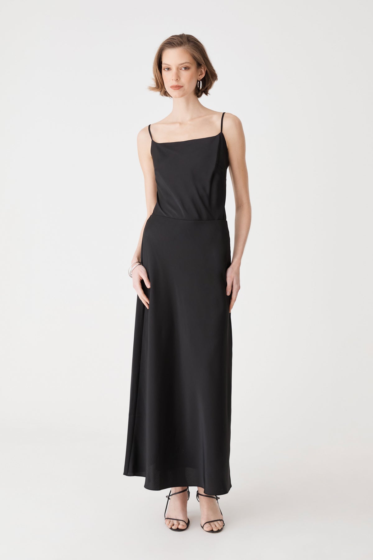 Louise Bias Satin Skirt in black, front view, maxi length worn with a black camisole top