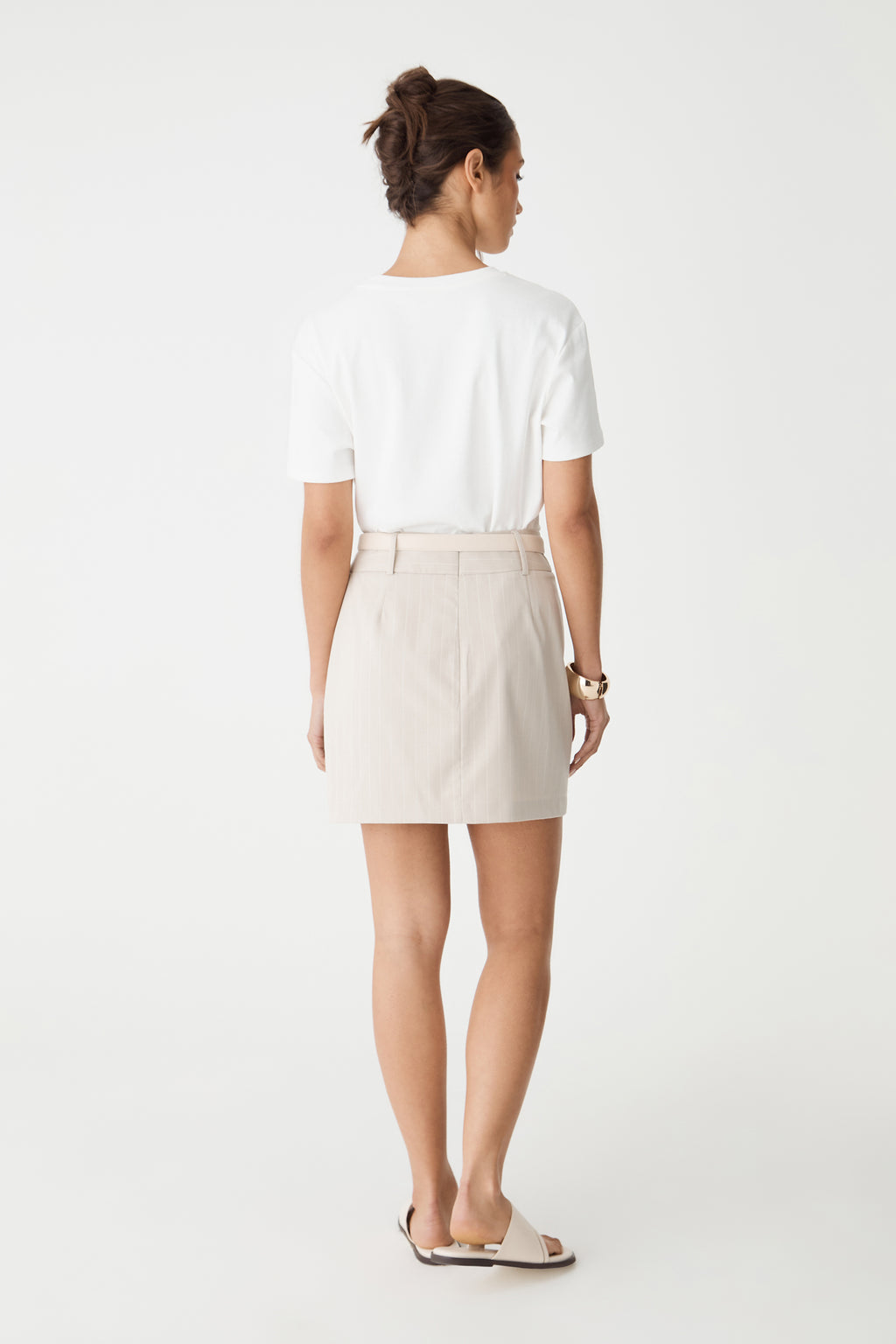 Back view of the beige pinstripe mini skirt with invisible back zip