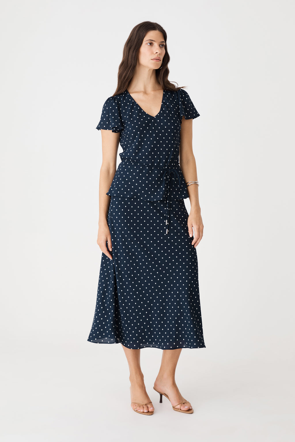 Front view showing self-tie waist belt and peplum-style hem