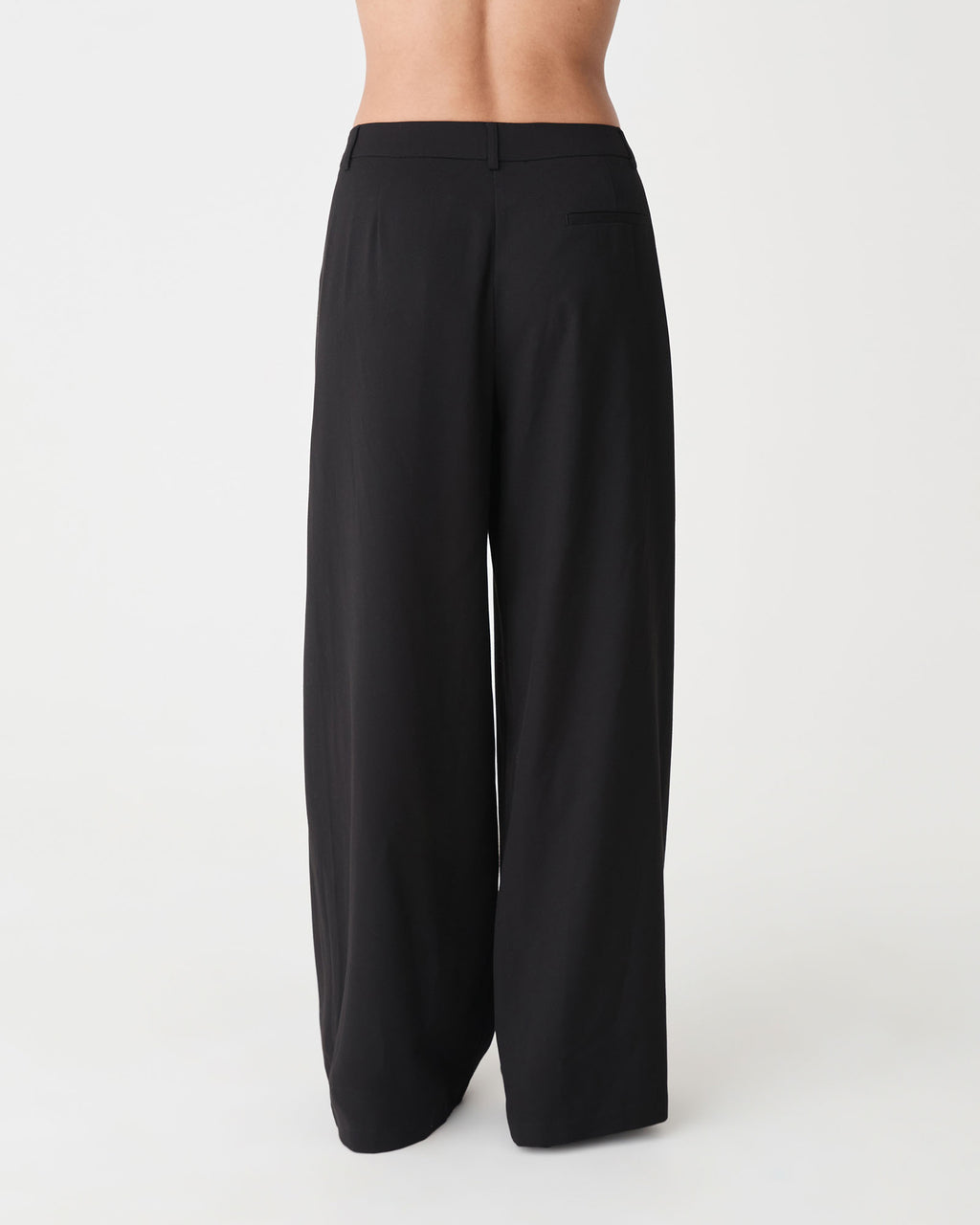 Arden Mid Rise Pleated Pants in black — back view