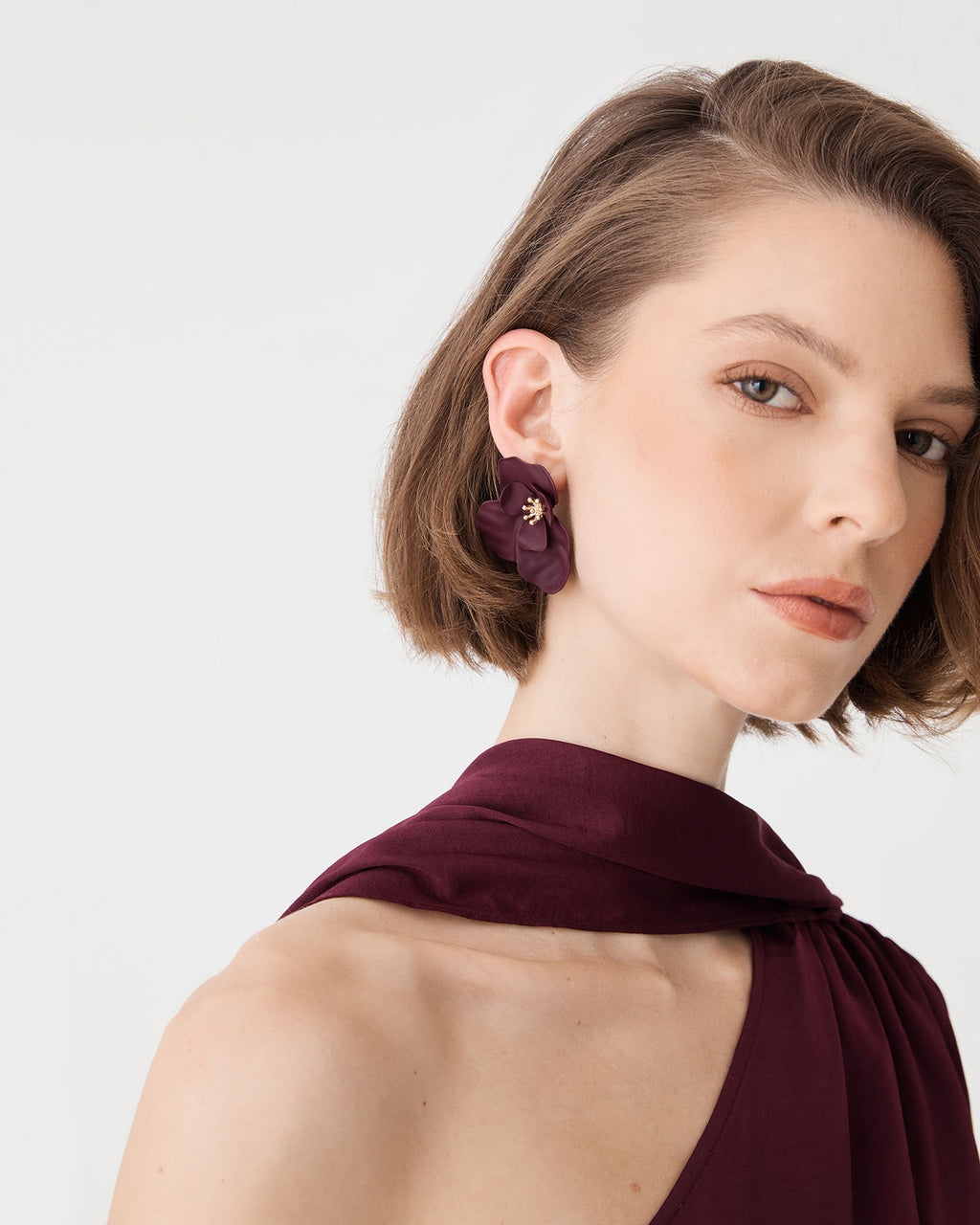 Front view of Amara Bloom Earrings worn with a burgundy halter top