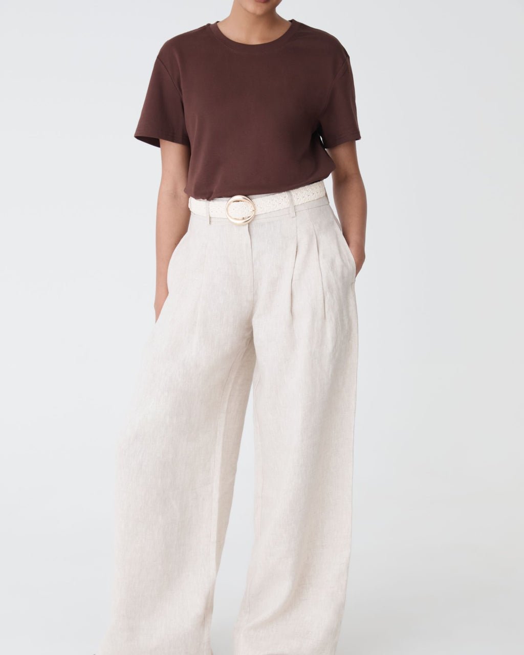 Front view of ivory Elena Crochet Belt worn at the waist of wide-leg linen trousers